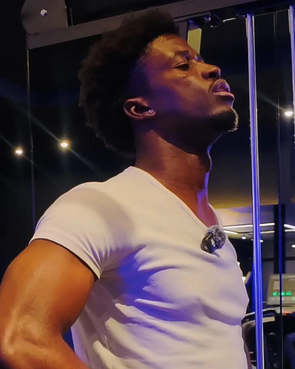 Enock Ipassou on location with a lapel microphone clipped to his shirt